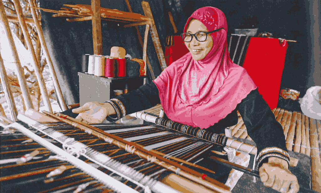 Junia owner of traditional rungus fabric weaving business